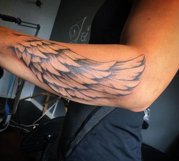 angel wings tattoo on arm