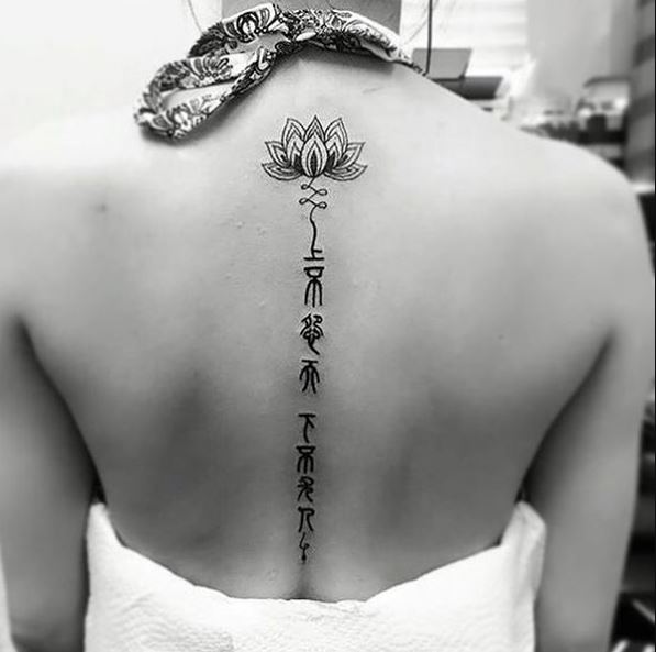 Lotus And Fonts Spine Tattoos Designs