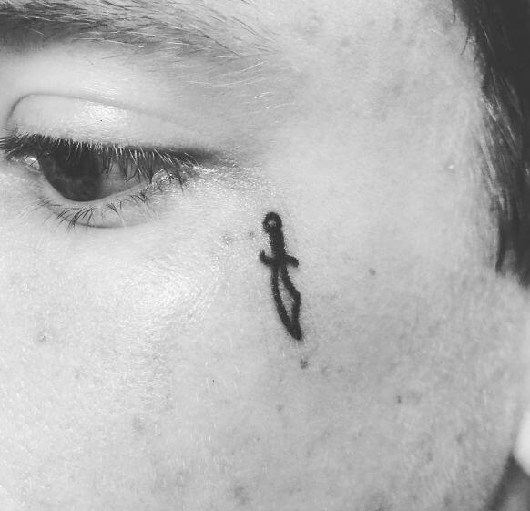 Tiny Dagger Tattoos On Face