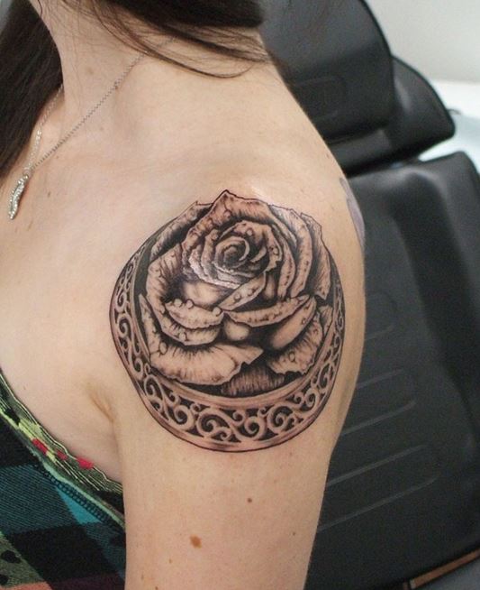 Pink rose tattoo on the right shoulder blade