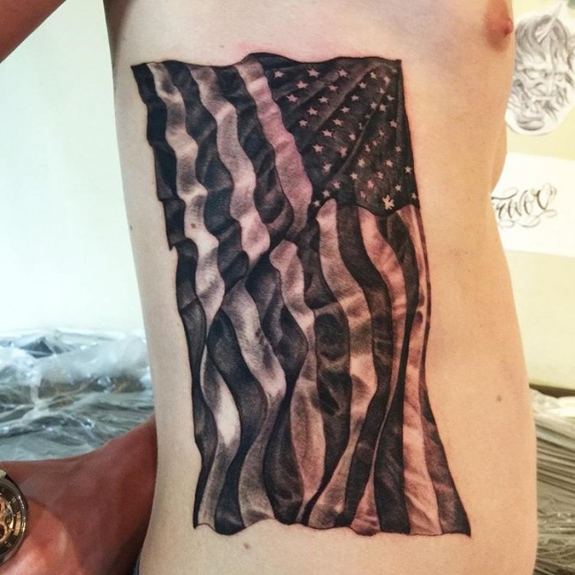Flying Black US Flag Tattoo On Side Rib