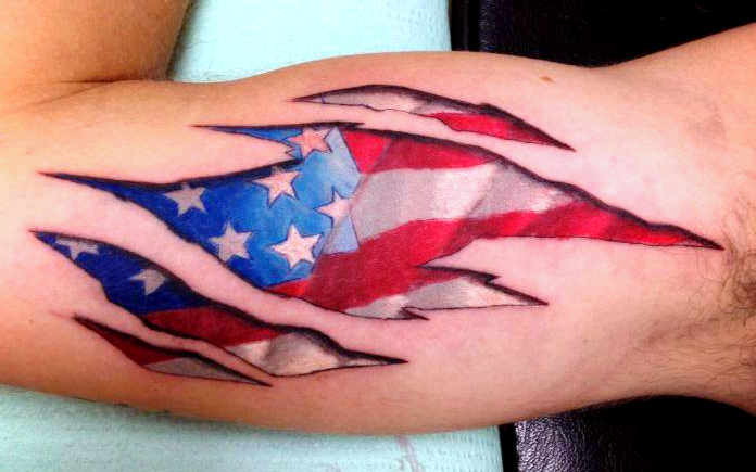 Impressive Ripped Skin USA Flag Tattoo On Biceps