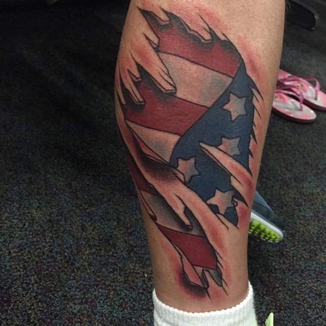 Ripped Skin American Flag Tattoo On Leg