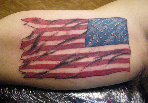 Torn American Flag Tattoo On Biceps