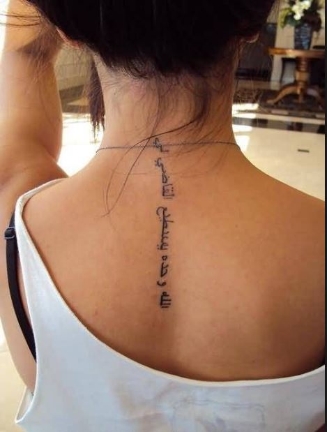 Great Looking Arabic Letter Tattoo On Women's Upper Back