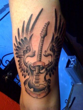 A Guitar Tattoo Design With Wings Symbolizing The Sense Of Freedom Found In Music 336x448