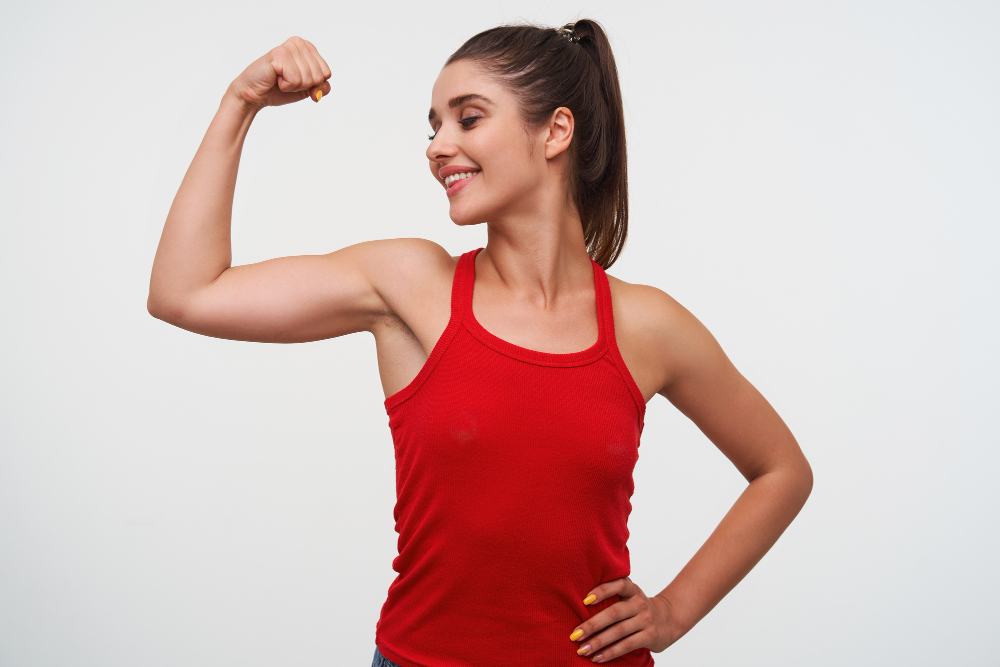 Portrait Young Smiling Cute Brunette Woman Wears Red T Shirt Demonstrates Beceps Excellent Fitness Form Stands White Background