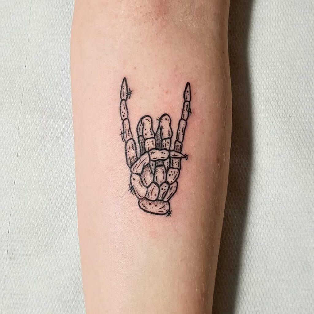 Rock hand tattoo meaning and ideas in 2023